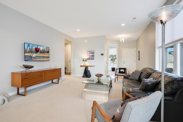 living area featuring visible vents, recessed lighting, baseboards, and light carpet