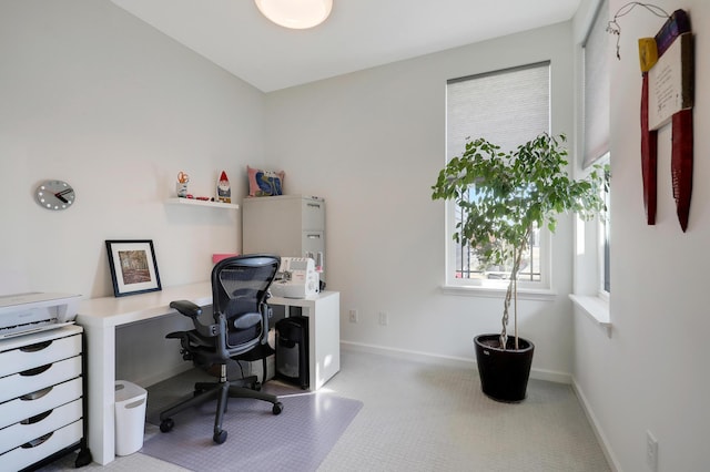 carpeted home office with baseboards