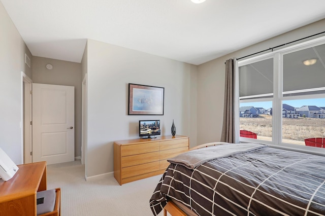 bedroom featuring light carpet, visible vents, and baseboards