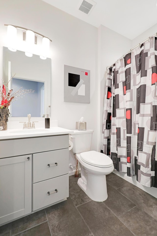 bathroom featuring vanity, a shower with shower curtain, visible vents, tile patterned floors, and toilet