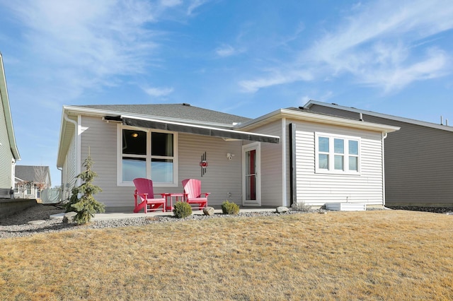 rear view of property with a lawn and covered porch