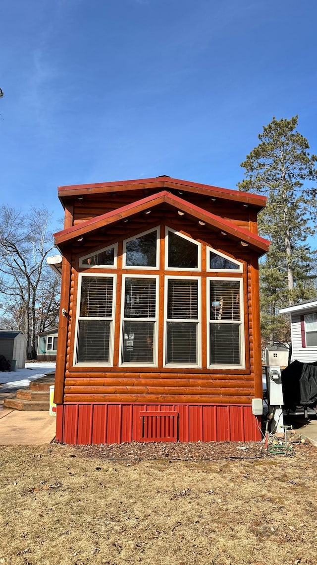 view of side of home with faux log siding