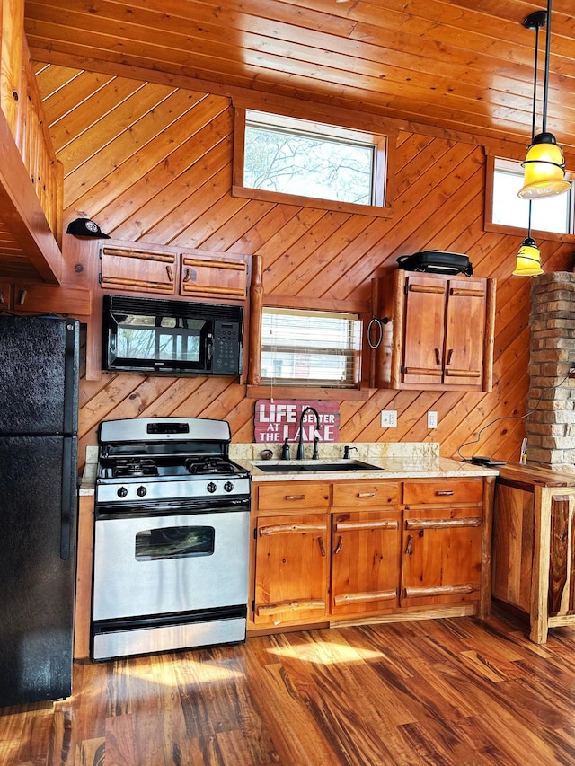 kitchen featuring wooden walls, a sink, black appliances, light countertops, and wooden ceiling