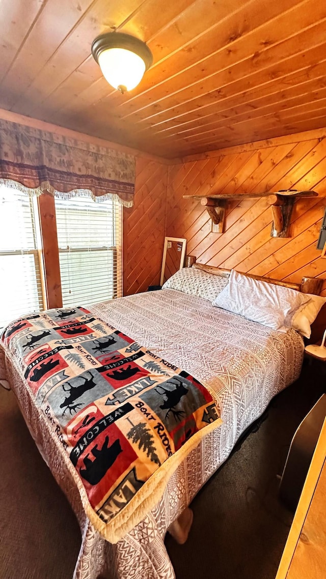 bedroom with wood walls and wooden ceiling