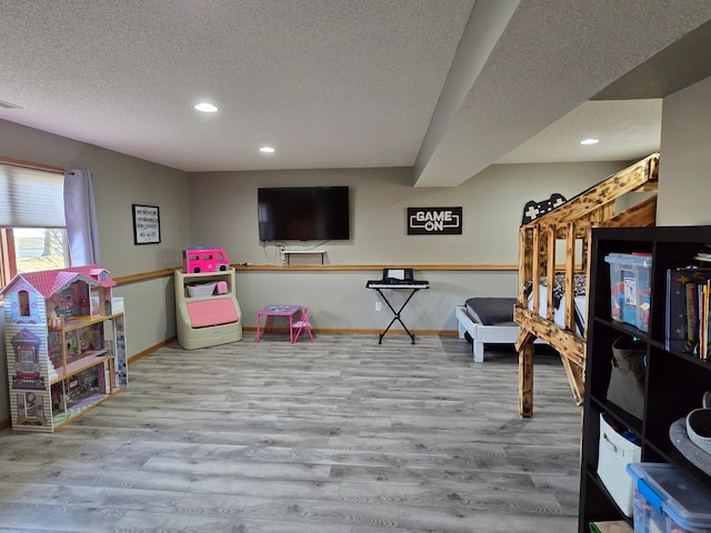 game room with recessed lighting, baseboards, a textured ceiling, and wood finished floors