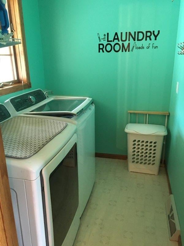 laundry area with light floors, visible vents, baseboards, laundry area, and separate washer and dryer