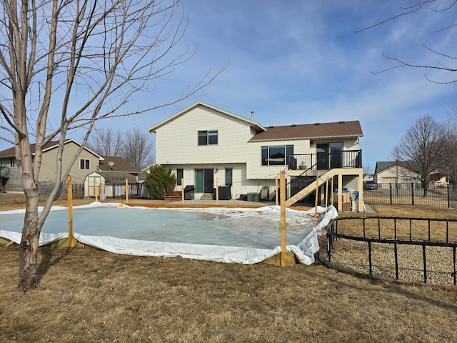 back of house with a playground, fence, and a wooden deck