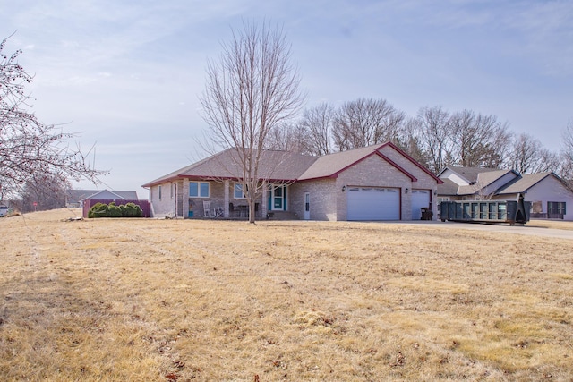 ranch-style house featuring brick siding and a garage