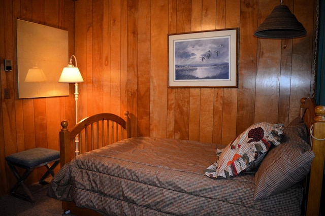 bedroom with wood walls