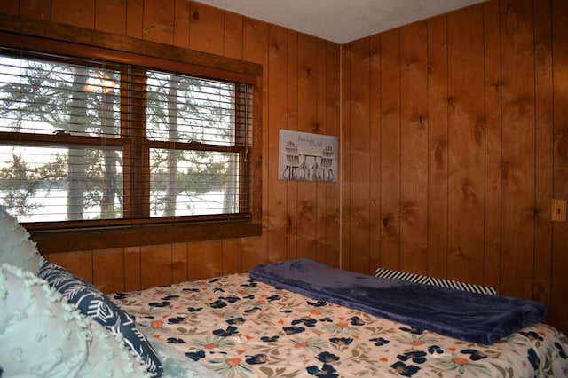 bedroom with wooden walls