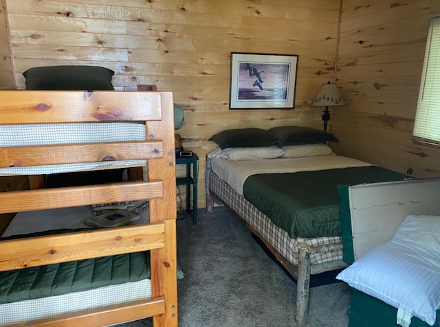 carpeted bedroom with wooden walls