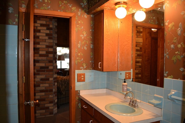 bathroom featuring wallpapered walls and vanity