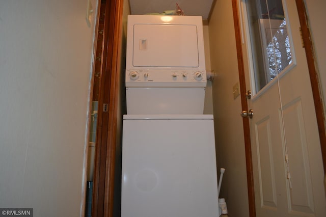 laundry area with stacked washer and dryer and laundry area