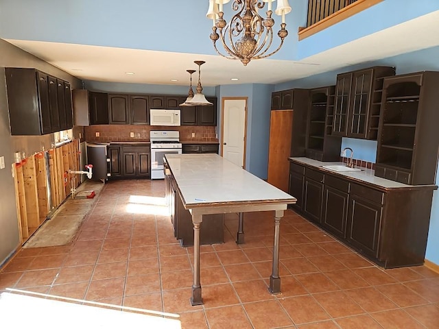 kitchen featuring white appliances, light tile patterned flooring, backsplash, and a sink