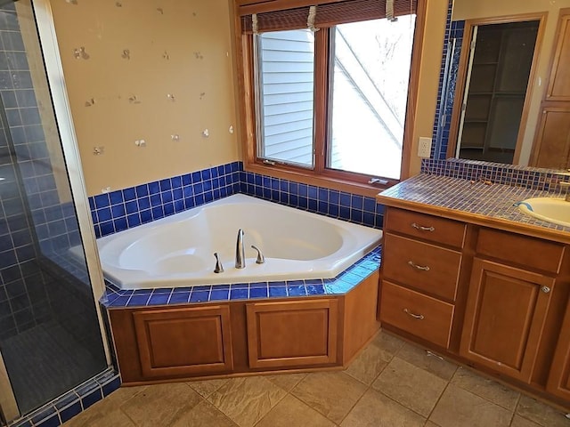 bathroom featuring vanity, a shower stall, a bath, and tile patterned floors