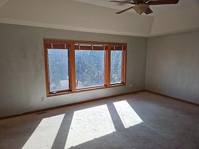 spare room featuring visible vents, plenty of natural light, baseboards, and ceiling fan