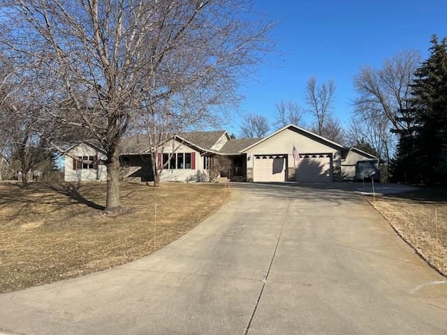 ranch-style home featuring an attached garage and driveway