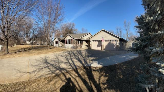 single story home with a garage and driveway