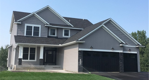 craftsman-style home featuring a garage and aphalt driveway