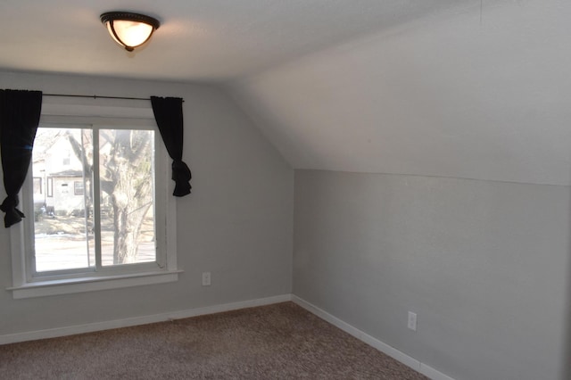 bonus room featuring carpet floors, a healthy amount of sunlight, baseboards, and vaulted ceiling