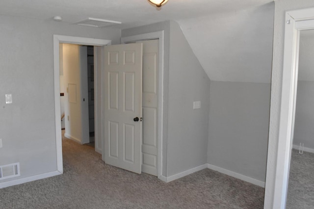 bonus room with baseboards, visible vents, attic access, lofted ceiling, and carpet flooring