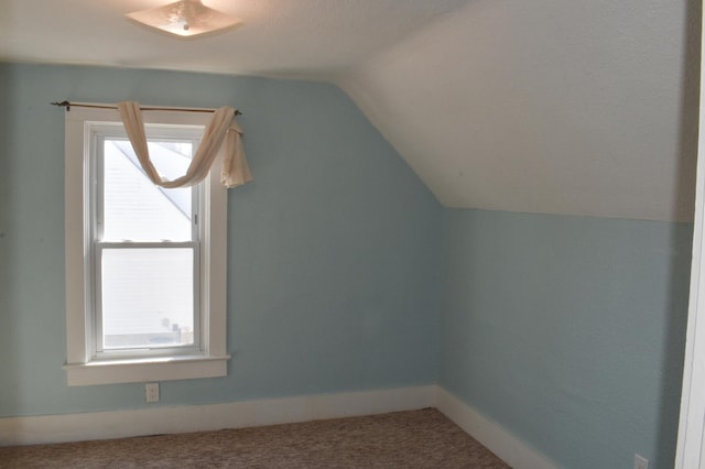 bonus room with a healthy amount of sunlight, baseboards, lofted ceiling, and carpet floors