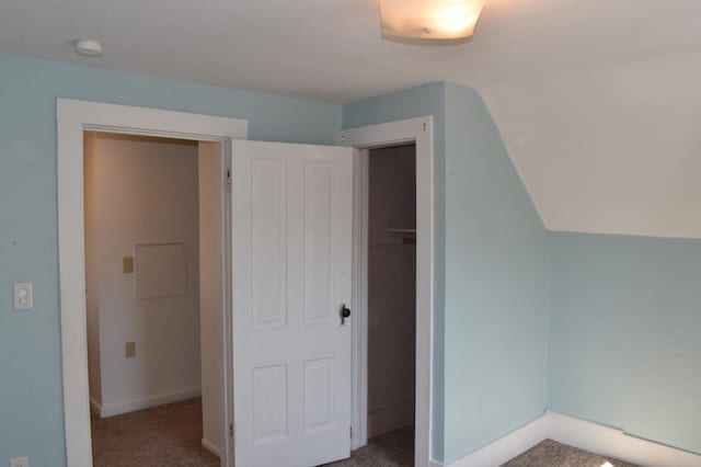 bonus room with baseboards and carpet floors