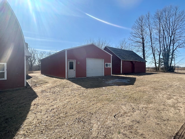 view of pole building with a yard and driveway