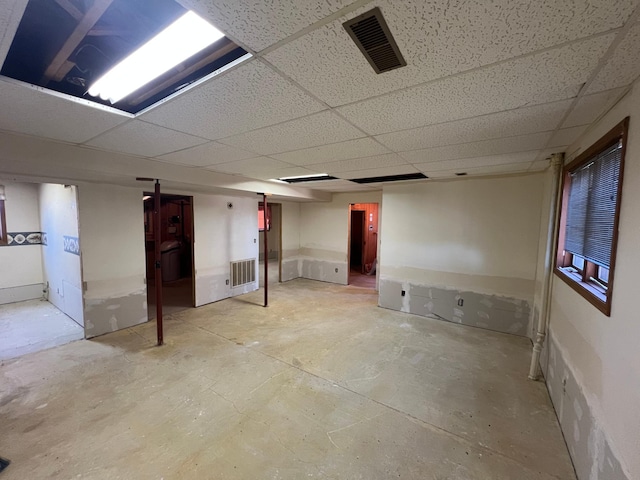 finished basement with visible vents and a drop ceiling