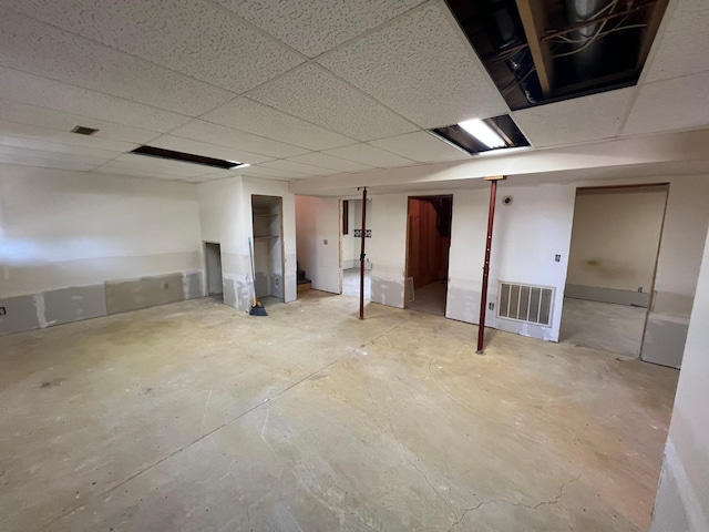 finished basement with a drop ceiling and visible vents