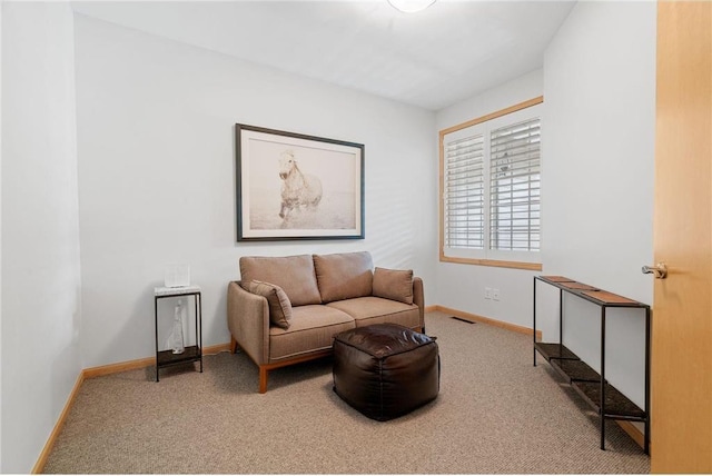 sitting room featuring visible vents, carpet flooring, and baseboards