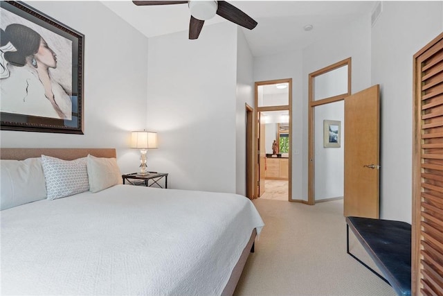 bedroom with baseboards, visible vents, ceiling fan, light carpet, and connected bathroom