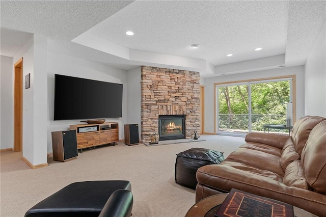 carpeted living area featuring a stone fireplace, recessed lighting, baseboards, and a textured ceiling