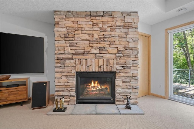 room details with carpet, a fireplace, baseboards, and a textured ceiling