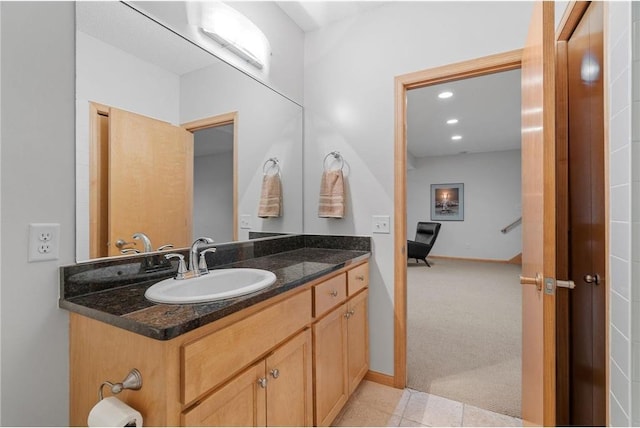 bathroom featuring vanity, recessed lighting, and baseboards