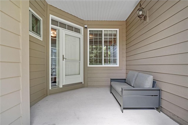 entrance to property featuring an outdoor living space and a patio