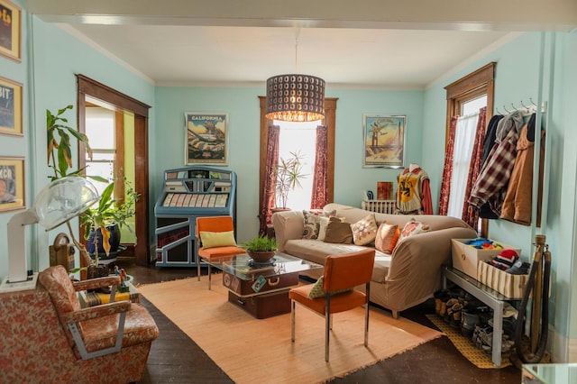 sitting room with wood finished floors and crown molding