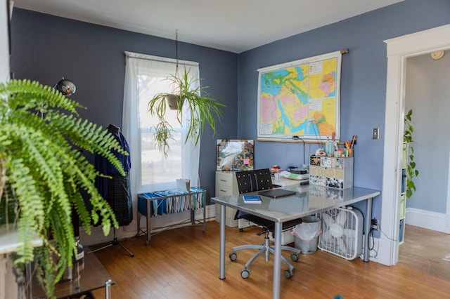 home office featuring baseboards and wood finished floors