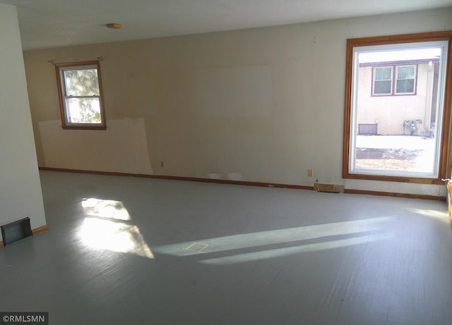 unfurnished room with baseboards