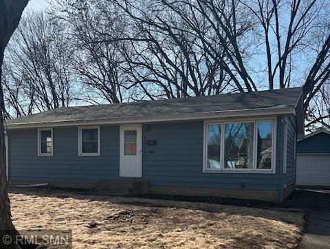 ranch-style home with an outbuilding, driveway, and a garage