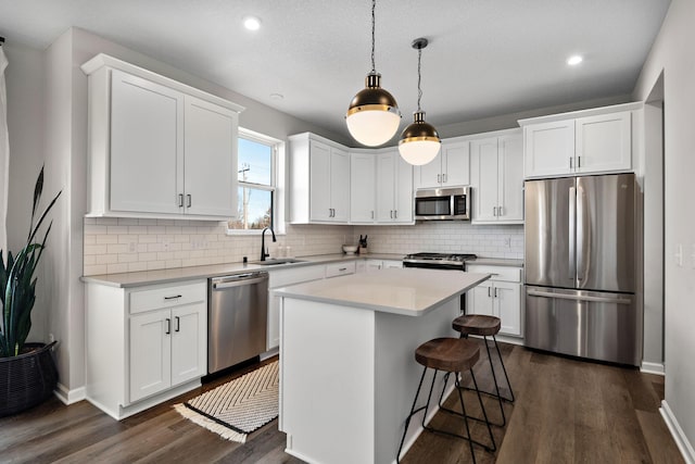 kitchen featuring a sink, appliances with stainless steel finishes, and white cabinetry