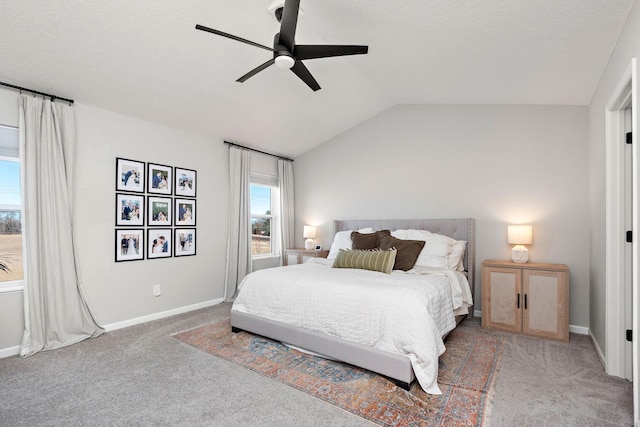 carpeted bedroom featuring baseboards, a ceiling fan, and vaulted ceiling