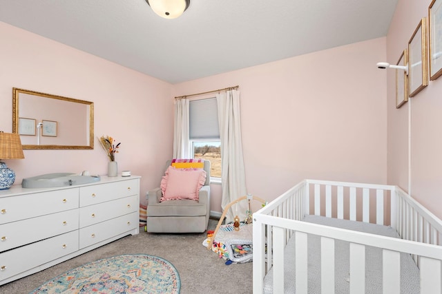 bedroom with a crib and light carpet