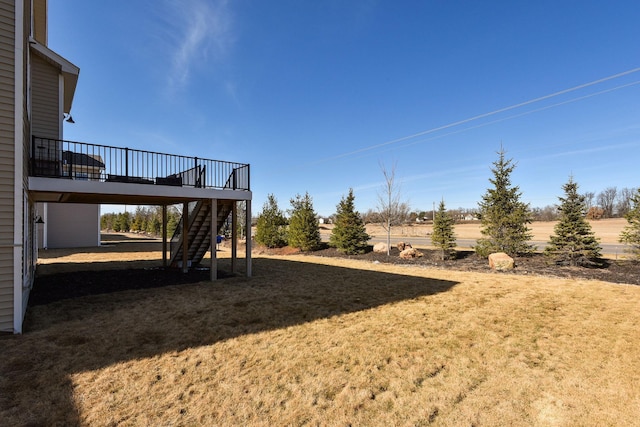 view of yard with stairway and a deck