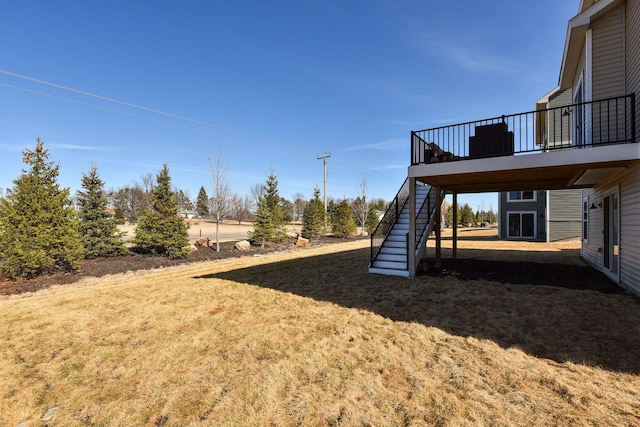 view of yard featuring a wooden deck and stairs