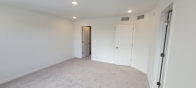 unfurnished bedroom with recessed lighting, carpet flooring, baseboards, and visible vents