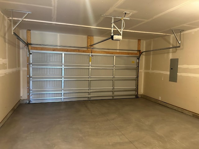 garage with electric panel, a garage door opener, and baseboards