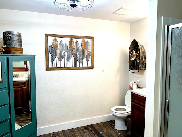114 Bay View Rd, Otter Tail Twp, MN 56571 - full bathroom with vanity, wood finished floors, baseboards, toilet, and a shower with shower door