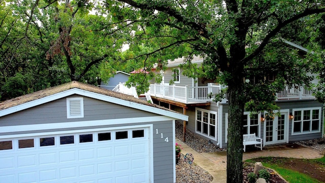 114 Bay View Rd, Otter Tail Twp, MN 56571 - obstructed view of property with french doors, an outbuilding, a balcony, and a garage