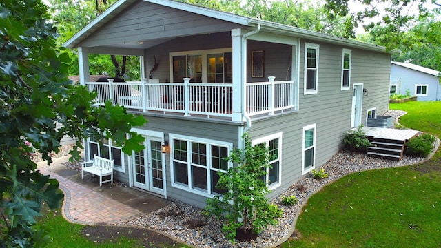 114 Bay View Rd, Otter Tail Twp, MN 56571 - rear view of house with a balcony, french doors, and a patio area